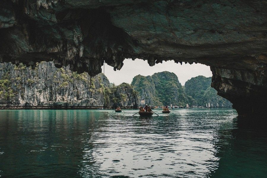 Experience a bamboo boat ride to visit caves in Ha Long Bay