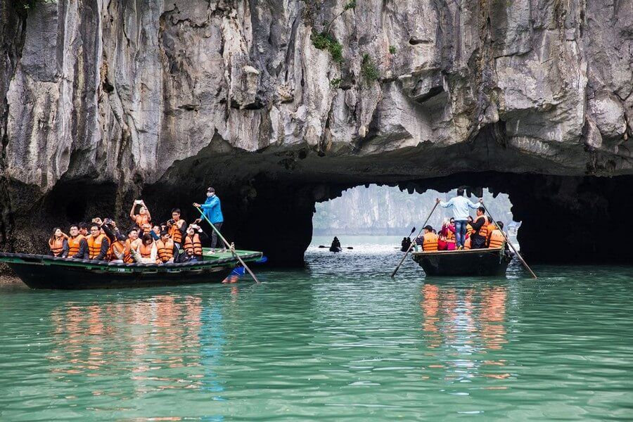 explore Luon Cave on a bamboo boat during a Halong Bay overnight cruise