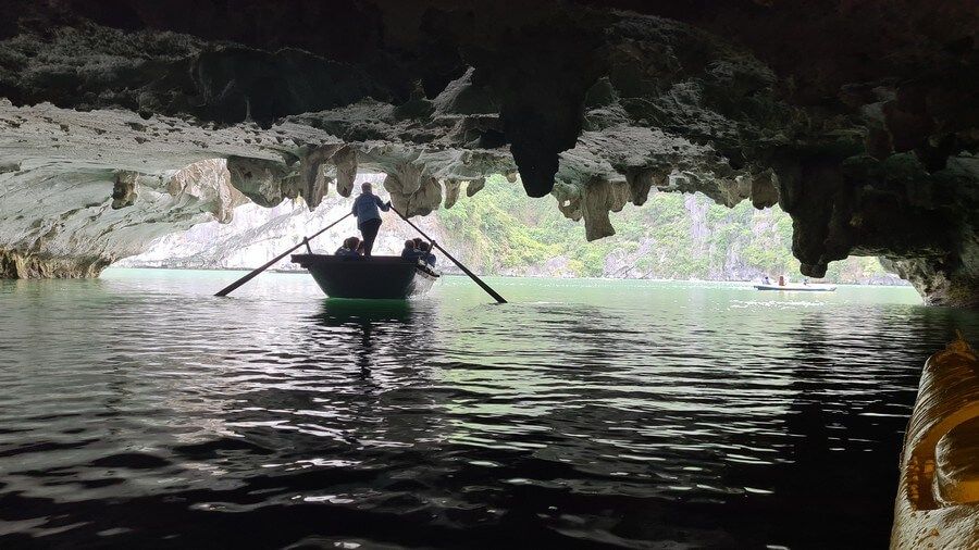 Sitting on the bamboo boat to visit Bright Cave