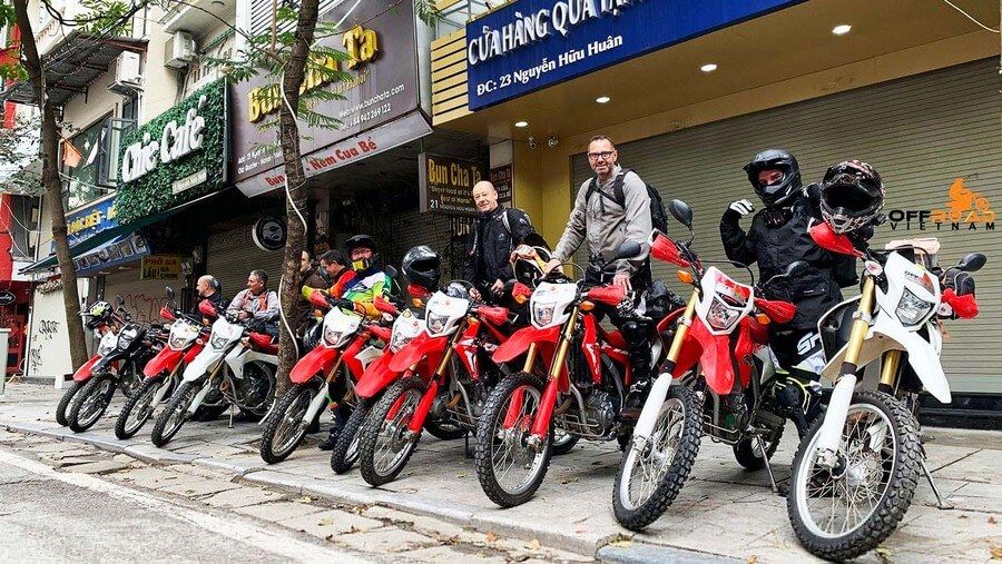 "Travelers explore Ha Long by motorbike."